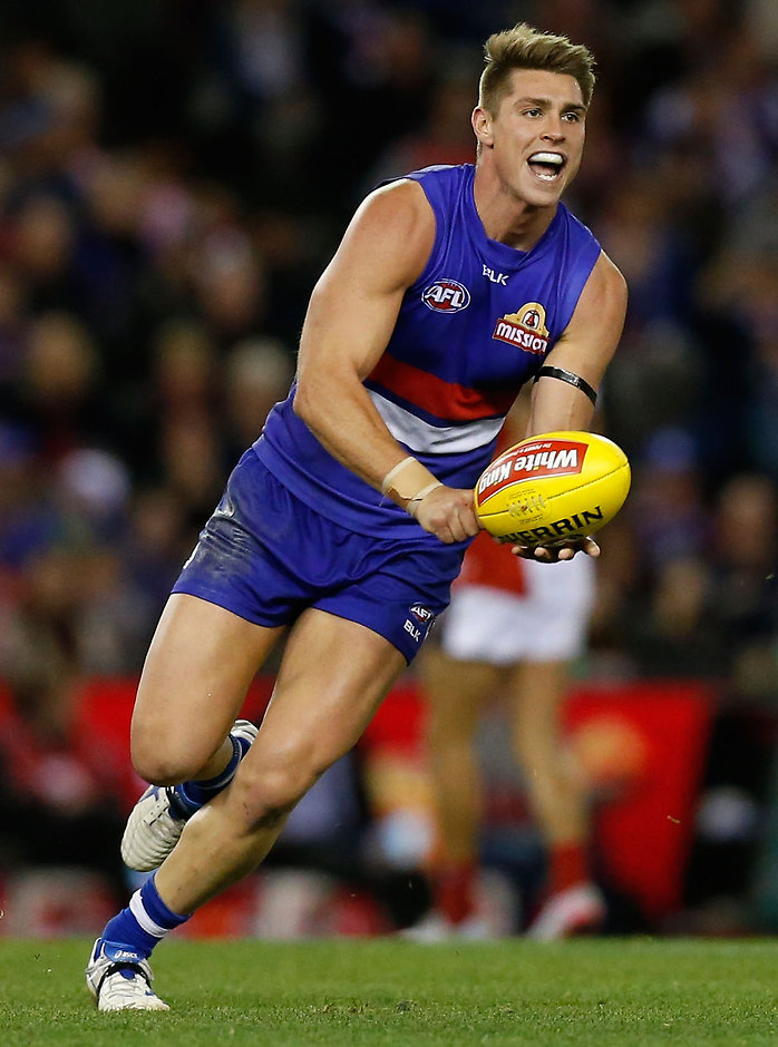 AFL 2015 Rd 20 - Western Bulldogs v Melbourne MELBOURNE, AUSTRALIA - AUGUST 16: Michael Talia of the Bulldogs handpasses the ball during the 2015 AFL round 20 match between the Western Bulldogs and the Melbourne Demons at Etihad Stadium, Melbourne, Australia on August 16, 2015. (Photo by Adam Trafford/AFL Media)